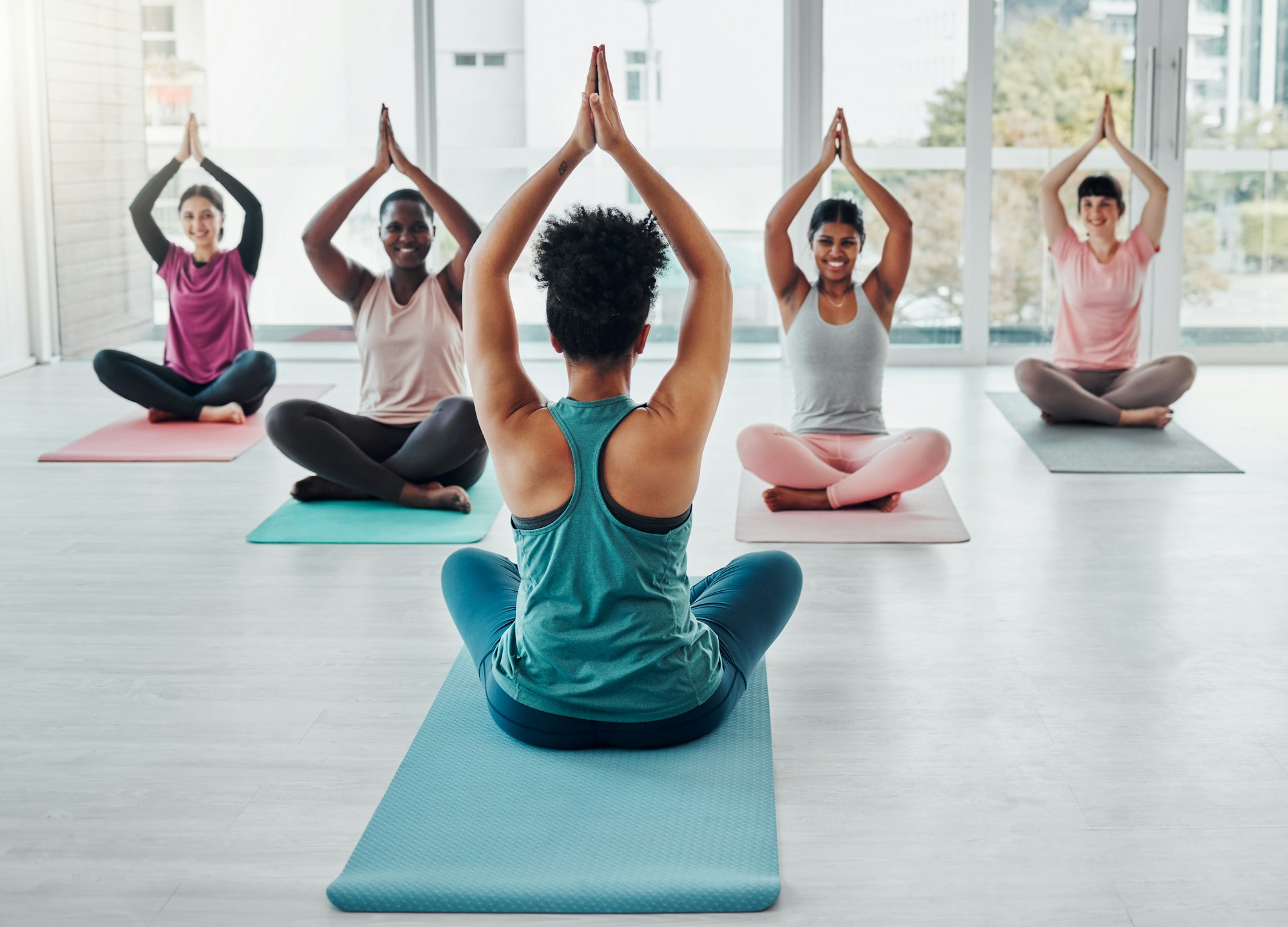 Diversity women in yoga class for meditation exercise for fitness, peace and wellness. Group and in